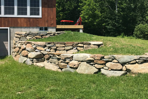 A stone retaining wall at a newly constructed home.